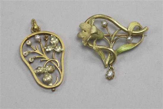 Two yellow metal foliate design pendants.